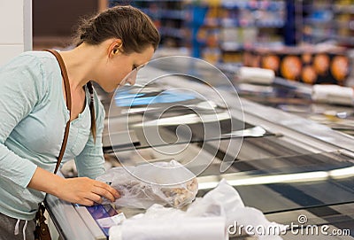 Beautiful young woman shopping for cereal, bulk in a grocery store Stock Photo