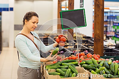 Beautiful young woman shopping for cereal, bulk in a grocery store Stock Photo