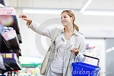 Beautiful young woman shopping in a grocery store/supermarket Stock Photo