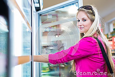 Beautiful young woman shopping in a grocery store/supermarket Stock Photo