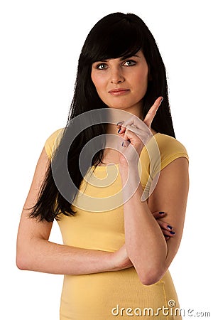 Beautiful young woman shows index finger as sign for being naughty Stock Photo