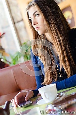 https://thumbs.dreamstime.com/x/beautiful-young-woman-sitting-alone-cafe-waiting-phone-call-pretty-girl-cup-tea-coffee-35922397.jpg