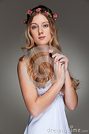 Beautiful young woman with small flower Stock Photo