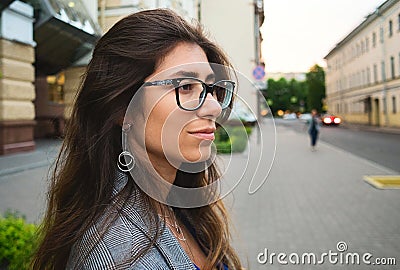 Beautiful young woman smiling cheerful walking on the street on a sunny day, casual pretty girl at the town Stock Photo