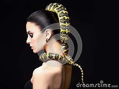 Beautiful young woman with Snake on her head Stock Photo