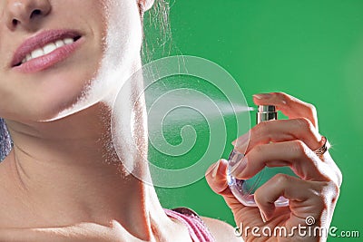 Beautiful young woman spraying parfume Stock Photo