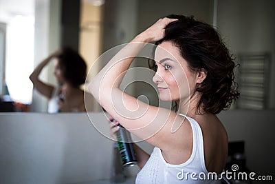 Beautiful young woman styling her her Stock Photo