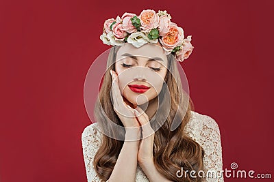 Beautiful young woman with summer pink flowers, long permed curly hair and fashion makeup Stock Photo