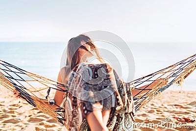 Beautiful young woman swing in hammok and enjoing sun light Stock Photo