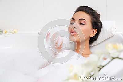 Beautiful young woman takes bubble bath Stock Photo