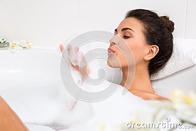 Beautiful young woman takes bubble bath Stock Photo