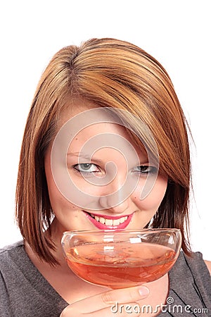 Beautiful young woman taking a sip of bubbly Stock Photo