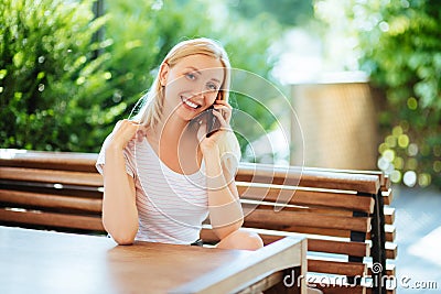 Beautiful young woman talking on mobile phone Stock Photo