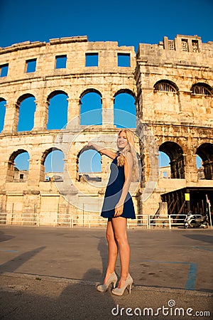 beautiful young woman turist taking photos of roman arena in Pula croatia Stock Photo