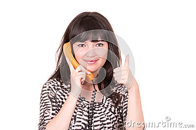 Beautiful young woman using retro orange telephone Stock Photo