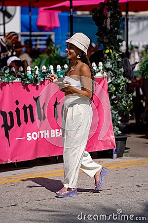 Beautiful young woman walking in Miami Beach to meet friends for spring break Editorial Stock Photo