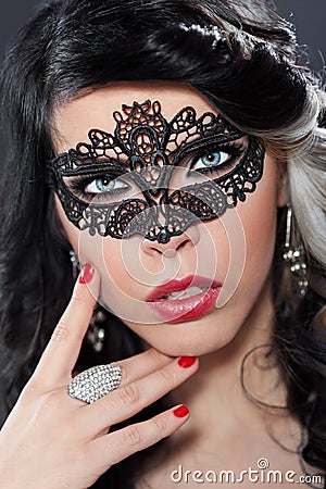Beautiful young woman wearing a face masque Stock Photo