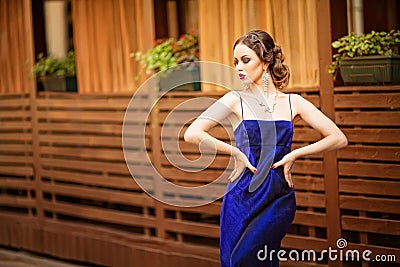 Beautiful young woman wearing a violet dress walking and posing Stock Photo