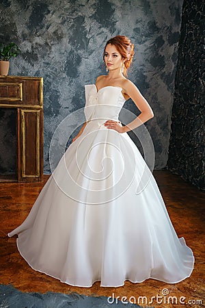 Beautiful young woman in wedding dress, romantic image of the bride, beautiful make-up and hairstyle Stock Photo