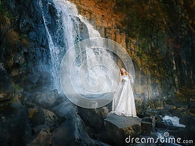 Beautiful young woman in a white dress in the middle of a forest Stock Photo