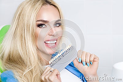 Beautiful, young woman with white and healthy teeth, she smiles. He has healthy and whitened teeth and porcelain veneers Stock Photo