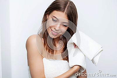 Beautiful young woman wipes her hairs with a towel. Stock Photo