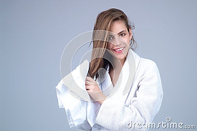 Beautiful young woman wiping hair. Happy young woman wrapped in towel with wet hairs. Natural hair. Smiling girl Stock Photo