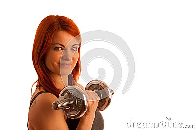 Beautiful young woman working out with dumbels in fitness gym Stock Photo