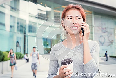 Beautiful young women call phone and hold coffee cup Stock Photo