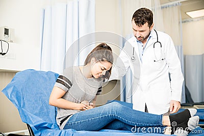 Woman with stomach ache visiting doctor Stock Photo