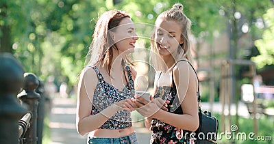 Beautiful young women watching photos on a phone. Stock Photo