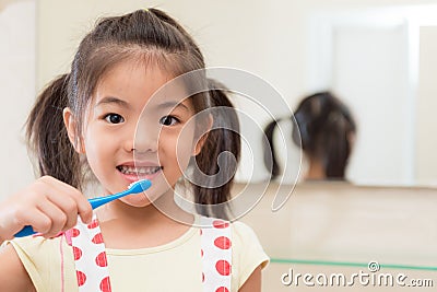 Beautiful youth kid daughter holding toothbrush Stock Photo