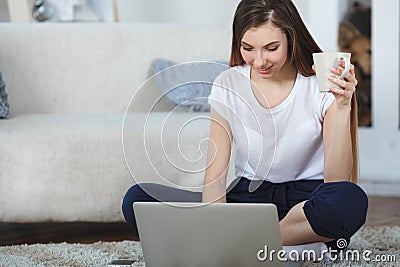 Beautiful ypung woman using laptop at home Stock Photo