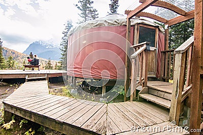 Forest Yurt Against Trees and Mountain Backdrop Editorial Stock Photo