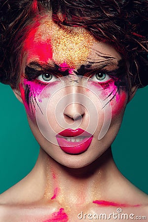 Beautifulgirl with creative colorful makeup on a green Stock Photo