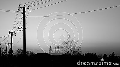 Beautifull black summer sunset sunset against the background village , building , trees and electricity power lines Stock Photo