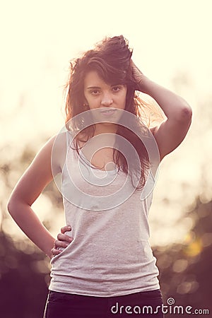 Beautifull girl with long black hair in the garden looking at you Stock Photo