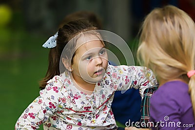 Beautifull little girl look to a friend curiously Editorial Stock Photo