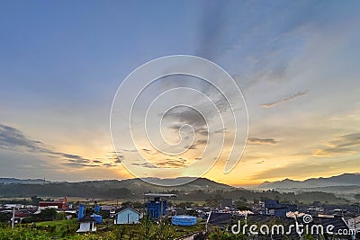 Beautifull sunrise in the morning behind the hills and the blue sky Stock Photo