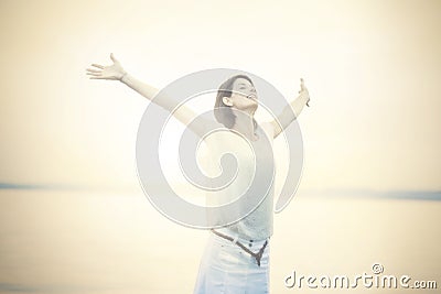 Beautifull woman taking a deep breath at the sunset Stock Photo