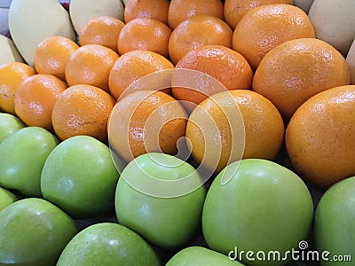 Beautifully arranged piles of oranges and apples Stock Photo