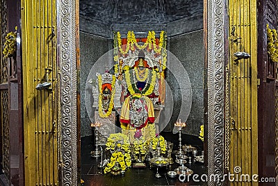 Beautifully decorated idol of Sri Lord Krishna Temple with flowers garlands and lights at Krishna Dhama, Mysuru.KARNATAKA, INDIA Stock Photo