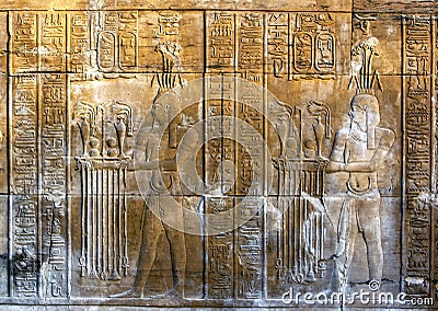 A beautifully decorated wall displaying engravings and hieroglyphs at the Temple of Kom Ombo in Egypt. Stock Photo