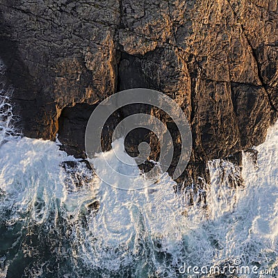 Beautifully detailed aerial drone landscape image of bird`s eye view of waves crashing over rocks at shore Stock Photo