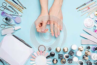 Beautifully manicured nails on the desktop with tools for manicure. Care about the nails Stock Photo