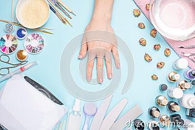 Beautifully manicured nails on the desktop with tools for manicure. Care about the nails Stock Photo