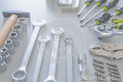 Beautifully placed on desk hand tools, such as: hammer, screwdriver, combination wrenches, hexagonal socket, bits, arm hexagonal Stock Photo