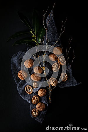 Beautifully presented walnuts on dark slate plate kitchen table Stock Photo