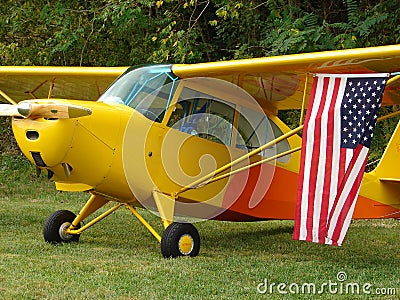 Beautifully restored classic Aeronca 7AC Champ Displaying US flag. Editorial Stock Photo