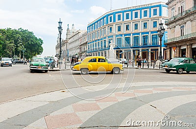 Beautifully restored Hotel Telegrafo across intersection of Paseo de MartÃ­, surrounded by dilapidated buildings with cars moving Editorial Stock Photo